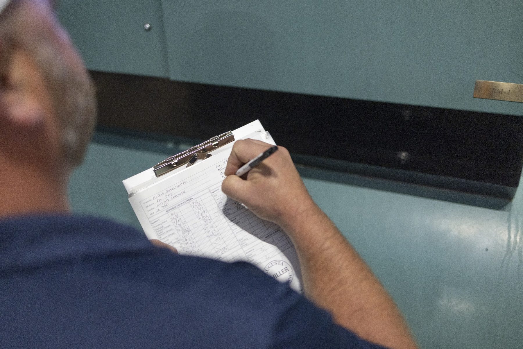 Augusta Chiller Service technician filling out a preventive maintenance report